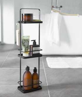 Black Portable Shower Caddy holding shower supplies in bathroom by Yamazaki Home. view 19