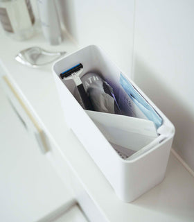 White Yamazaki Self-Draining Bathroom Organizer filled with bathroom products view 6