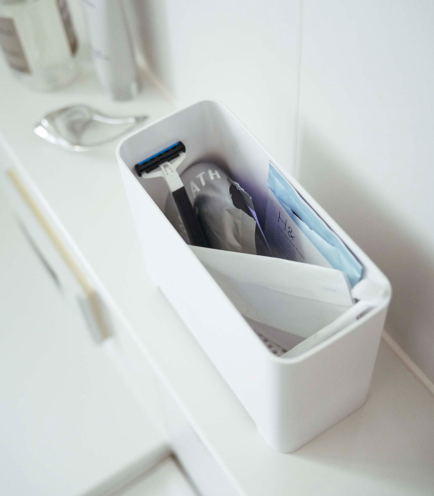 View 6 - White Yamazaki Self-Draining Bathroom Organizer filled with bathroom products