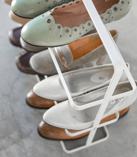 Close up of white Shoe Rack holding shoes by Yamazaki home. view 3