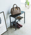 Side view of Black Shoe Organizer holding shoes and a purse by Yamazaki Home.