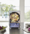 Front view of black Phone and Tablet Stand holding phone and tablet on kitchen counter by Yamazaki Home.