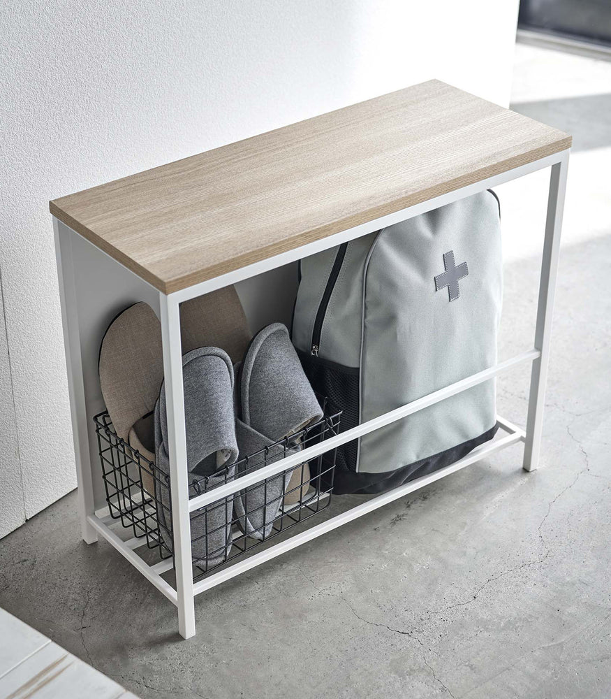 View 4 - White Yamazaki Discreet Entryway Storage Shelf filled with slippers and a backpack
