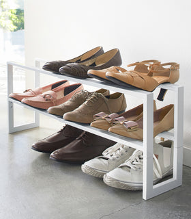 White Expandable Shoe Rack in entryway by Yamazaki home. view 14