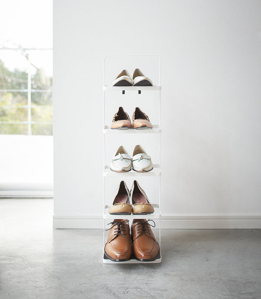 View 7 - Front view of white entryway Shoe Rack holding shoes by Yamazaki home.