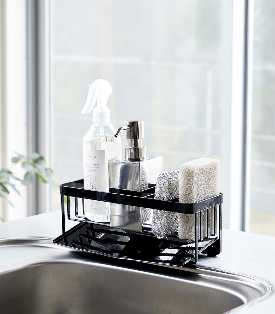 View 11 - Black steel sponge and soap bottle holder with black draining tray.