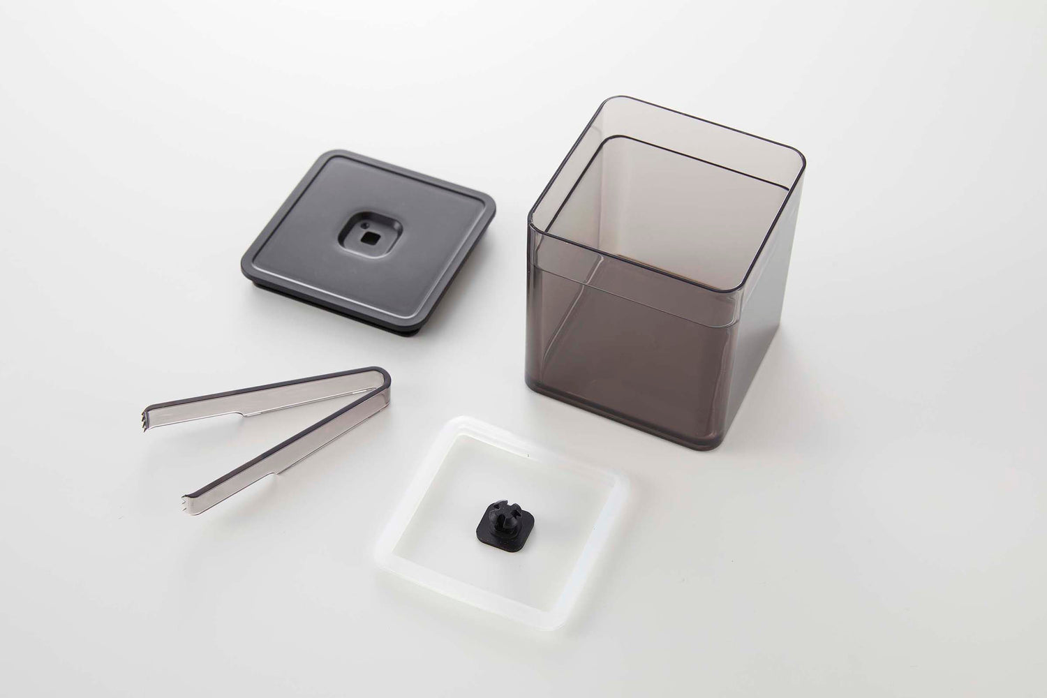 View 28 - Disassembled black Vacuum-Sealing Food Container w. Tongs on white background by Yamazaki Home.