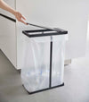 Black Yamazaki Home Lidded Garbage Bag Holder being opened