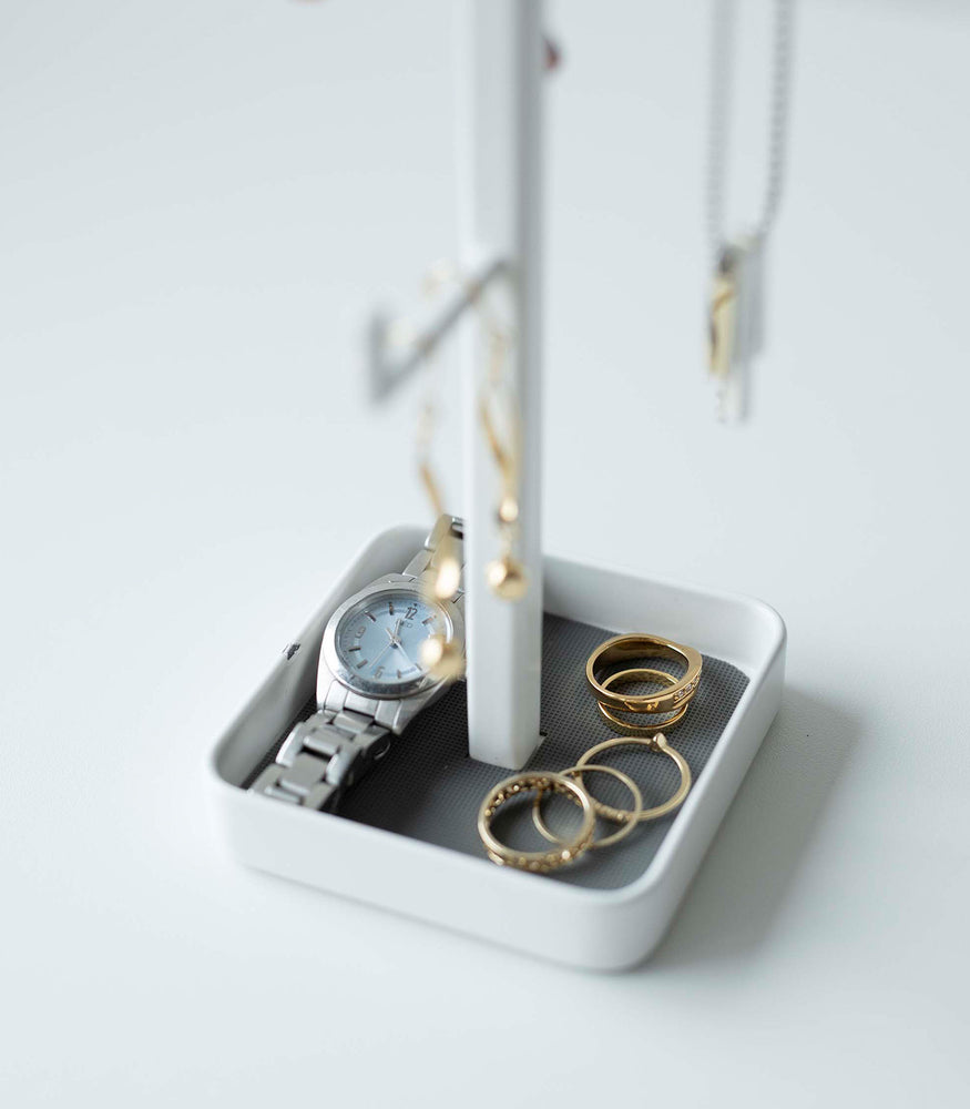 View 3 - Close up of white Yamazaki Home Tree Accessory Stand containing rings and a watch