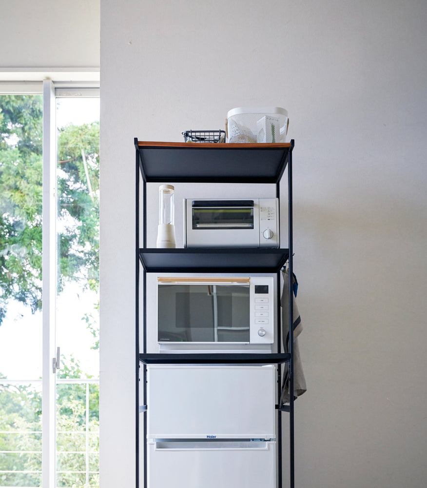 View 17 - Front view of black Storage Rack holding kitchen appliances by Yamazaki Home.