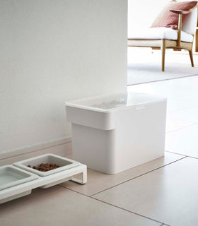 White Airtight Food Storage Container closed and holding pet food next to white Pet Food Bowl by Yamazaki Home. view 18