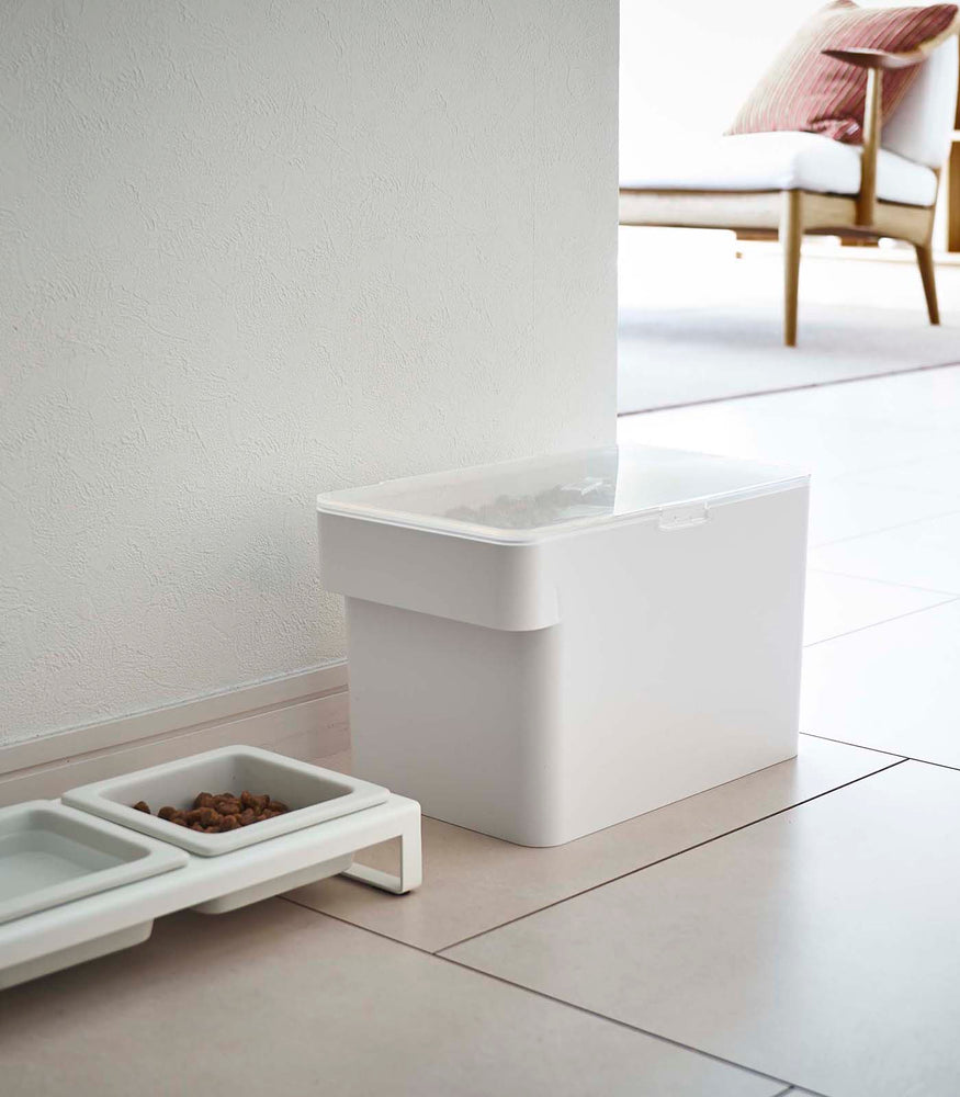 View 19 - White Airtight Food Storage Container closed and holding pet food next to white Pet Food Bowl by Yamazaki Home.