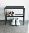 Front view of Black Shoe Organizer holding shoes by Yamazaki Home.