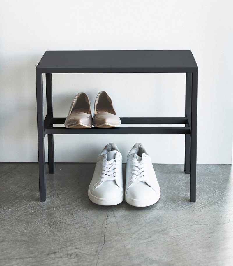 Front view of Black Shoe Organizer holding shoes by Yamazaki Home.