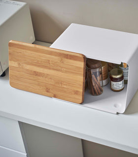 Top-down side view of white Yamazaki Bread Box with Cutting Board Lid partially open view 4