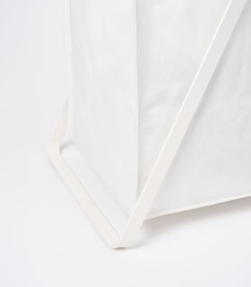 Photo showing part of the base of the small Laundry Hamper with Cotton Liner by Yamazaki Home in white. view 5