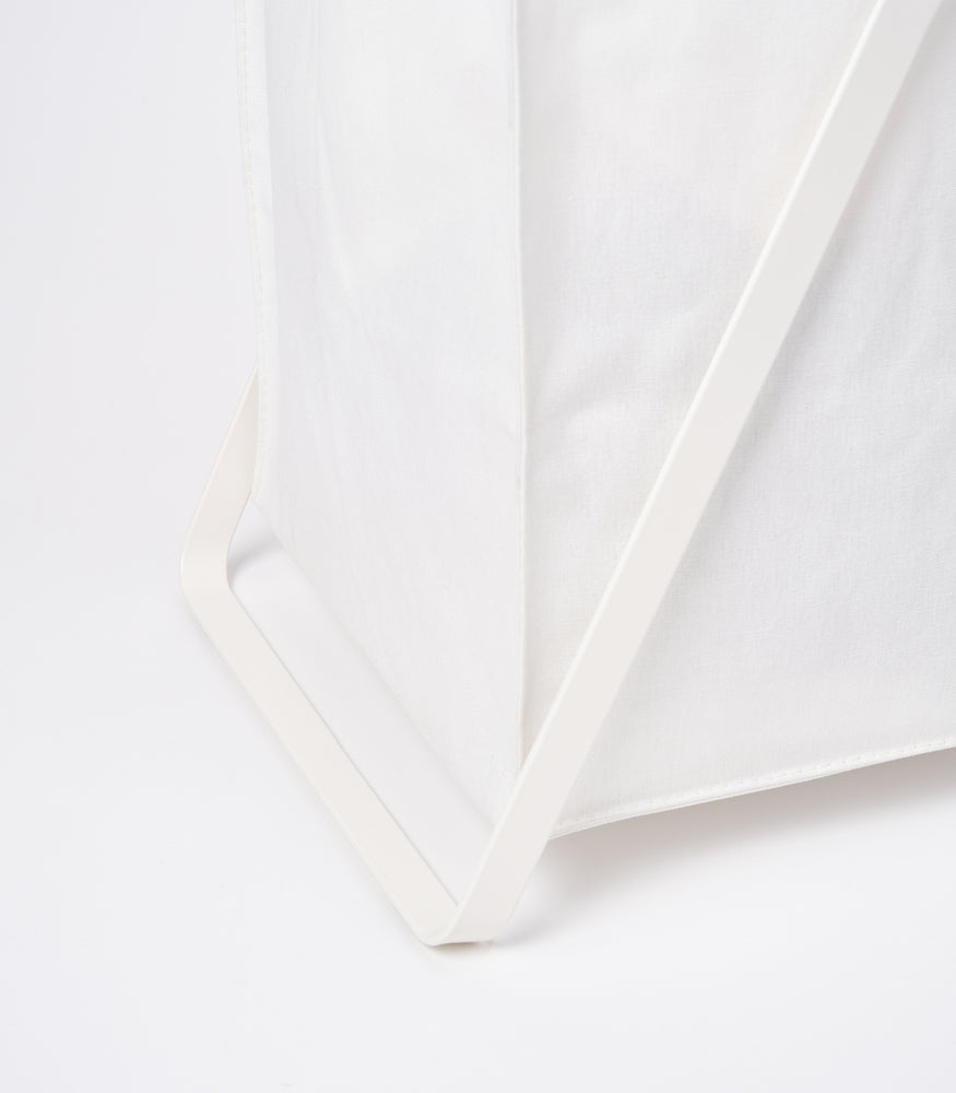 View 5 - Photo showing part of the base of the small Laundry Hamper with Cotton Liner by Yamazaki Home in white.