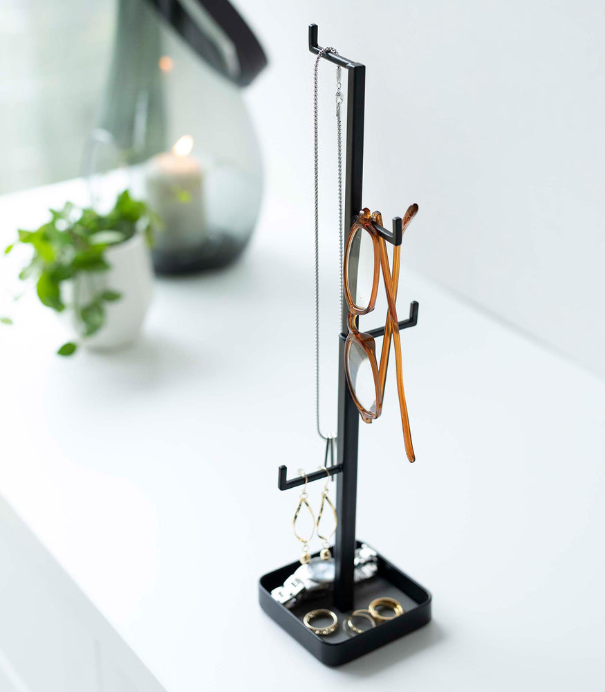 View 15 - Black Yamazaki Home Tree Accessory Stand with various accessories displayed