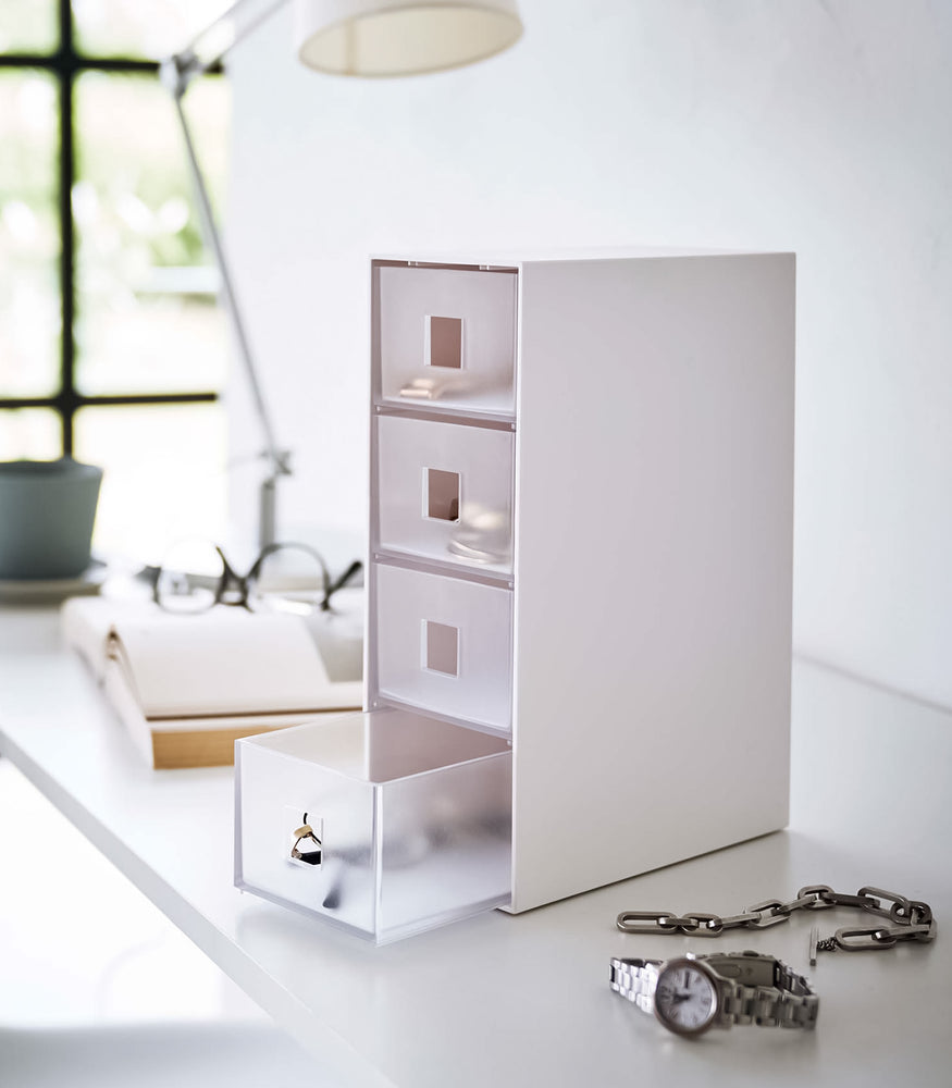 View 3 - White Yamazaki Home Storage Tower with Drawers with one drawer open filled with accessories