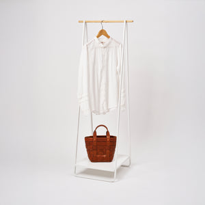 Yamazaki Home Coat Rack with Shelf with props, set against a white background.
