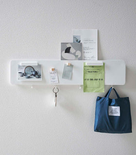 Yamazaki white Magnetic Wall Panel with things pinned to it with keys and a bag hanging from hooks view 5