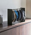 Shortened black Yamazaki Home hat rack hanging a variety of hats
