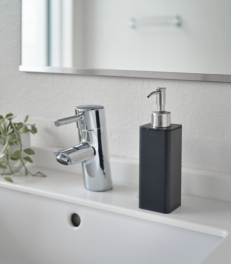 Black Hand Soap Dispenser on bathroom counter by Yamazaki Home.