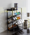 Black Four-Tier Slim Spice Rack by Yamazaki Home in a well-lit kitchen, equipped with a variety of spices and essentials.