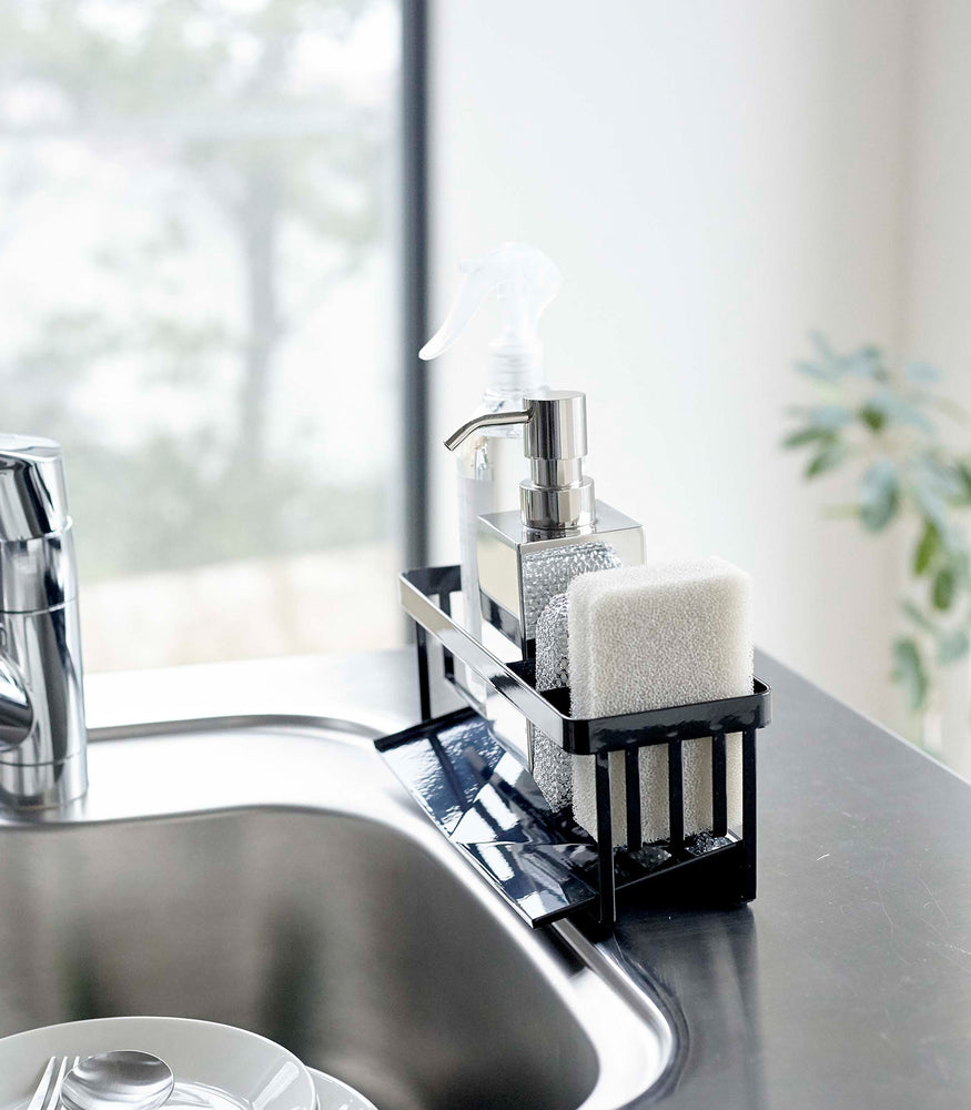 View 12 - Profile of black steel sponge and soap bottle holder with white draining tray.