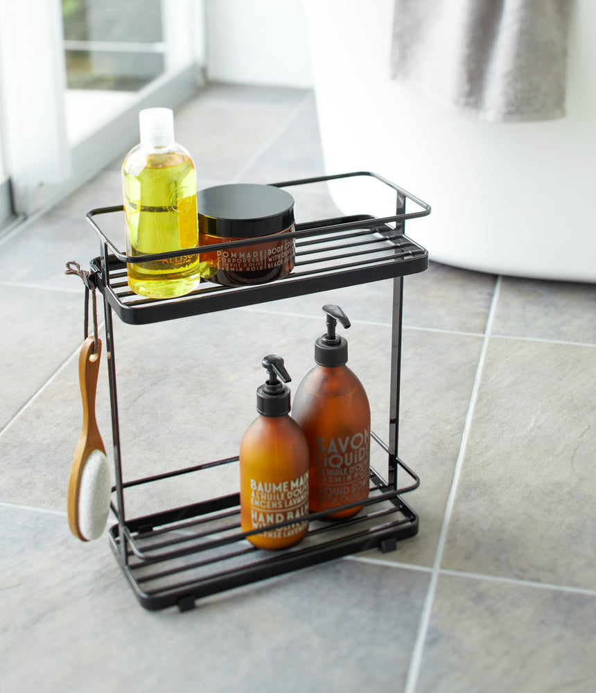 View 6 - Black Shower Caddy holding shower items in bathroom by Yamazaki Home.