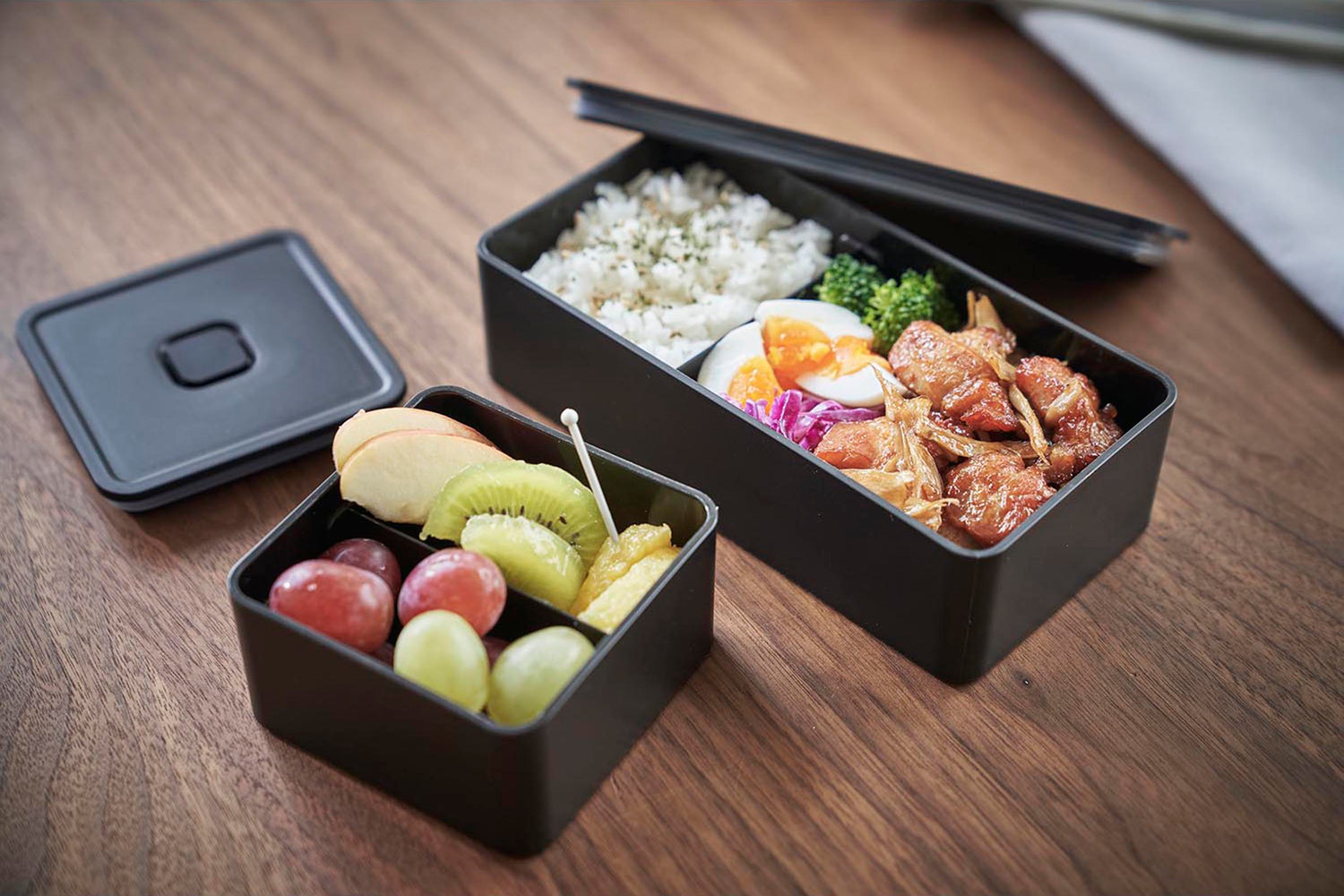 View 24 - Black Vacuum-Sealing Bento Box holding food on table by Yamazaki Home.