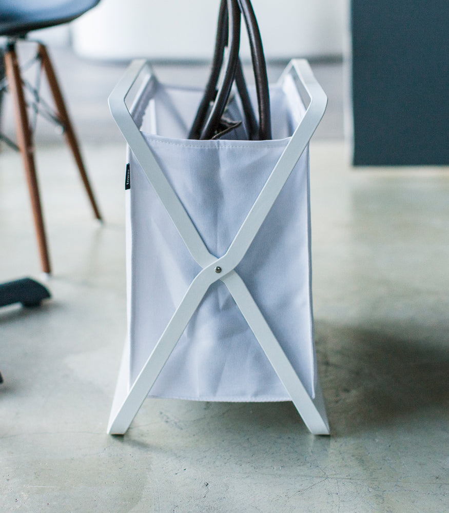 View 5 - Side view of white Storage Hamper holding purse by Yamazaki Home.