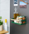 Side view of Forest Green Yamazaki Home Magnetic Storage Caddy with oil, herbs and spices stored attached to a refridgerator