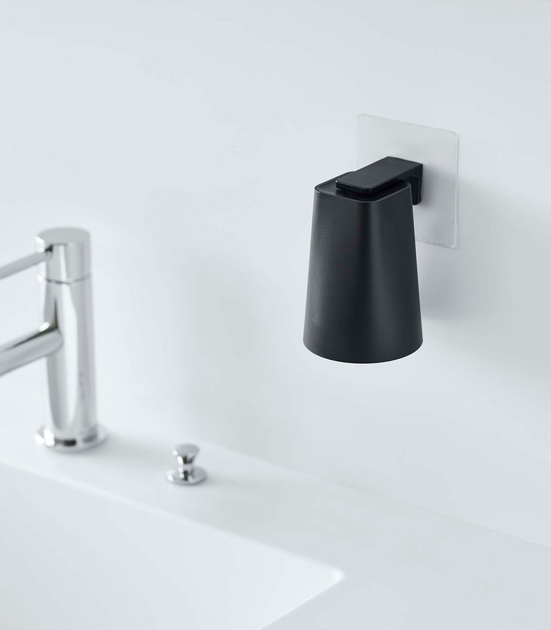 Black Yamazaki Home traceless adhesive magnetic cup installed next to sink