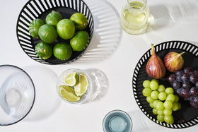 Aerial view of black Fruit Basket holding fruit on white tabletop by Yamazaki Home. view 8