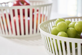 Close up side view of white Fruit Basket holding fruit on white background by Yamazaki Home. view 6