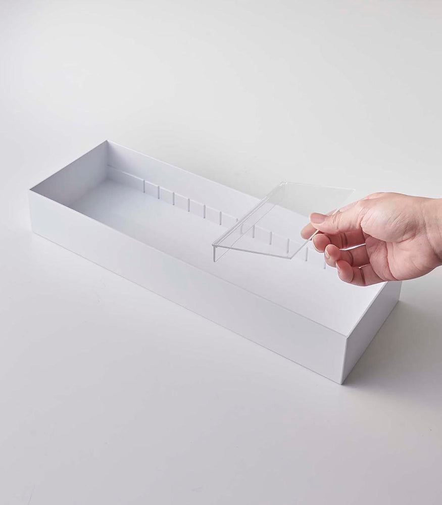 View 7 - Person inserting dividers in white Cutlery Storage Organizer on white background by Yamazaki Home.