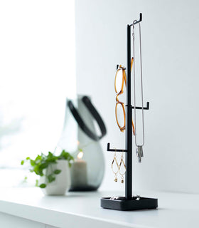 Black Yamazaki Home Tree Accessory Stand with glasses and other accessories displayed view 14