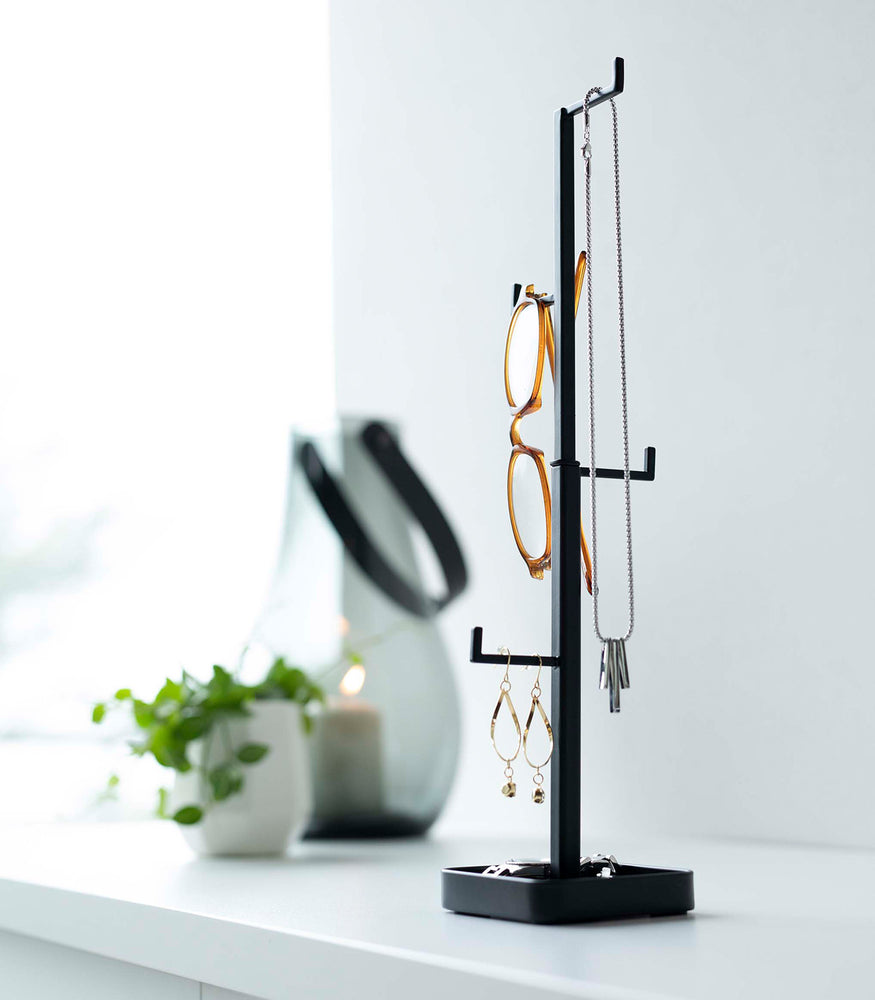 View 14 - Black Yamazaki Home Tree Accessory Stand with glasses and other accessories displayed