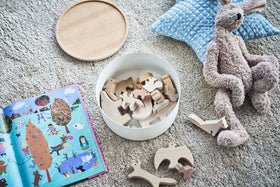 Yamazaki Home white Storage Case with wooden toys on carpet surrounded by other toys and a book view 19