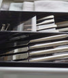 Close up side view of black Cutlery Storage Organizer holding silverware by Yamazaki Home.