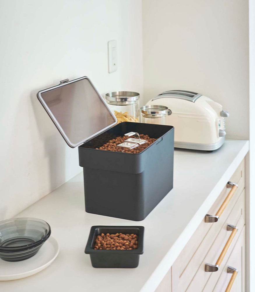 View 22 - Side view of black Airtight Food Storage Container holding pet food on countertop by Yamazaki Home.