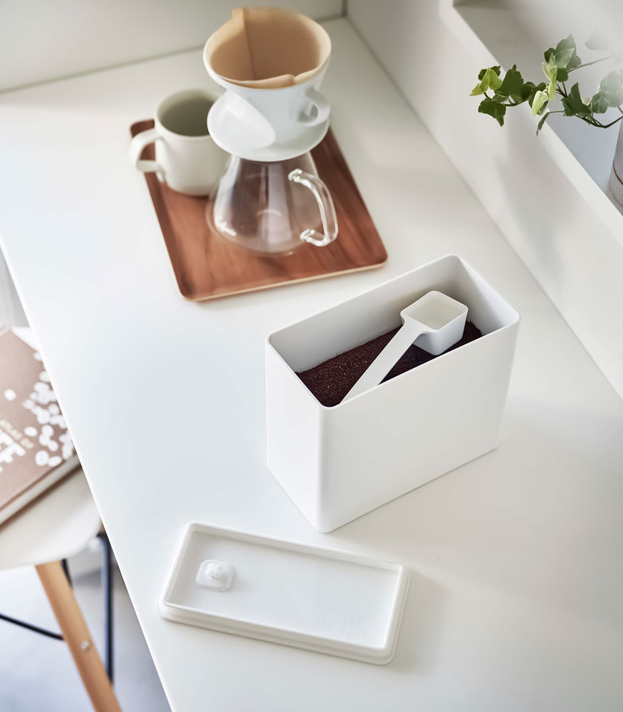 View 2 - White Yamazaki Home coffee storage container with an open lid and a measuring spoon inside