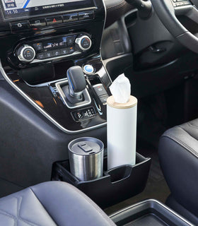 Small white Yamazaki Home Round Tissue Case in the center console cup holder of a car view 4
