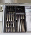 Aerial view of two black Cutlery Storage Organizers holding utensils in kitchen drawer by Yamazaki Home.