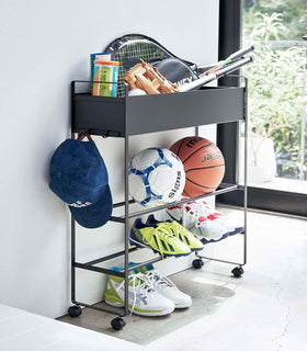 Black Yamazaki Entryway Organizer with shoes and sports equipment on it view 11