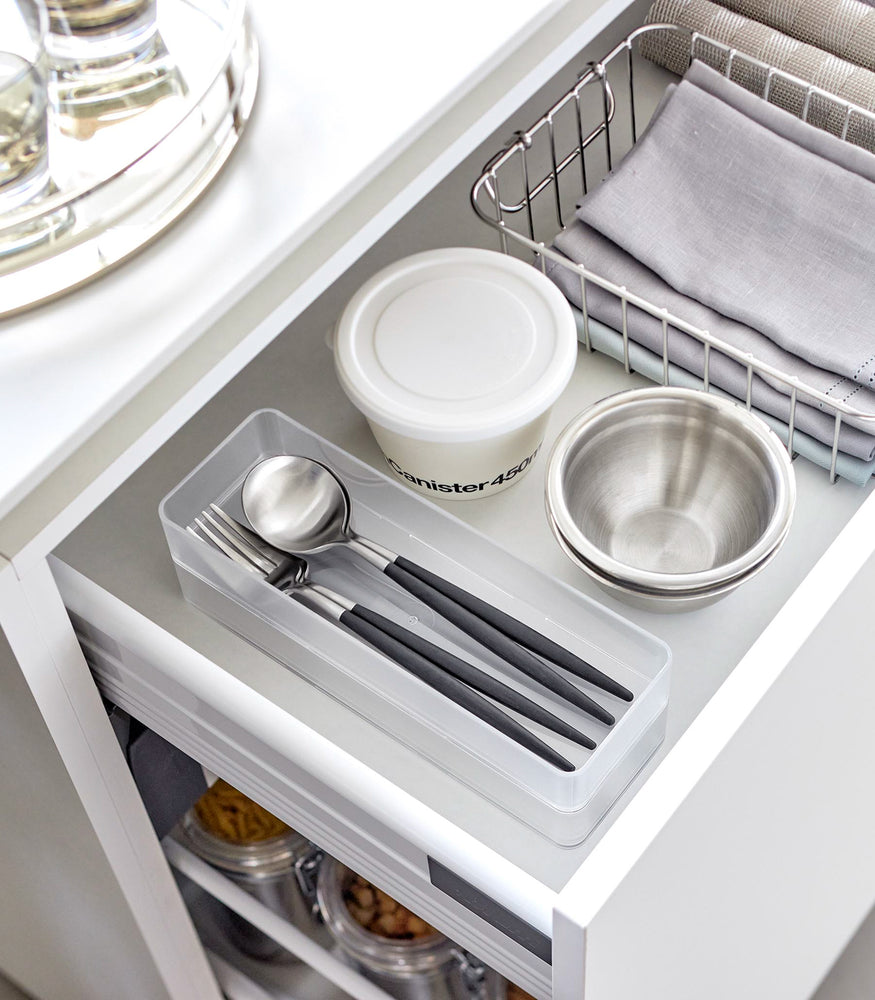 View 3 - Two large stackable clear organizers are placed in a kitchen drawer, organizing cutlery, neatly stacked together.