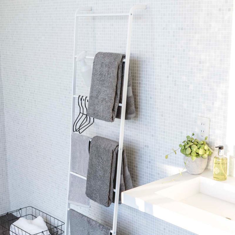 Side view of Leaning Ladder Hanger holding towels, hangers, and bathroom essentials.