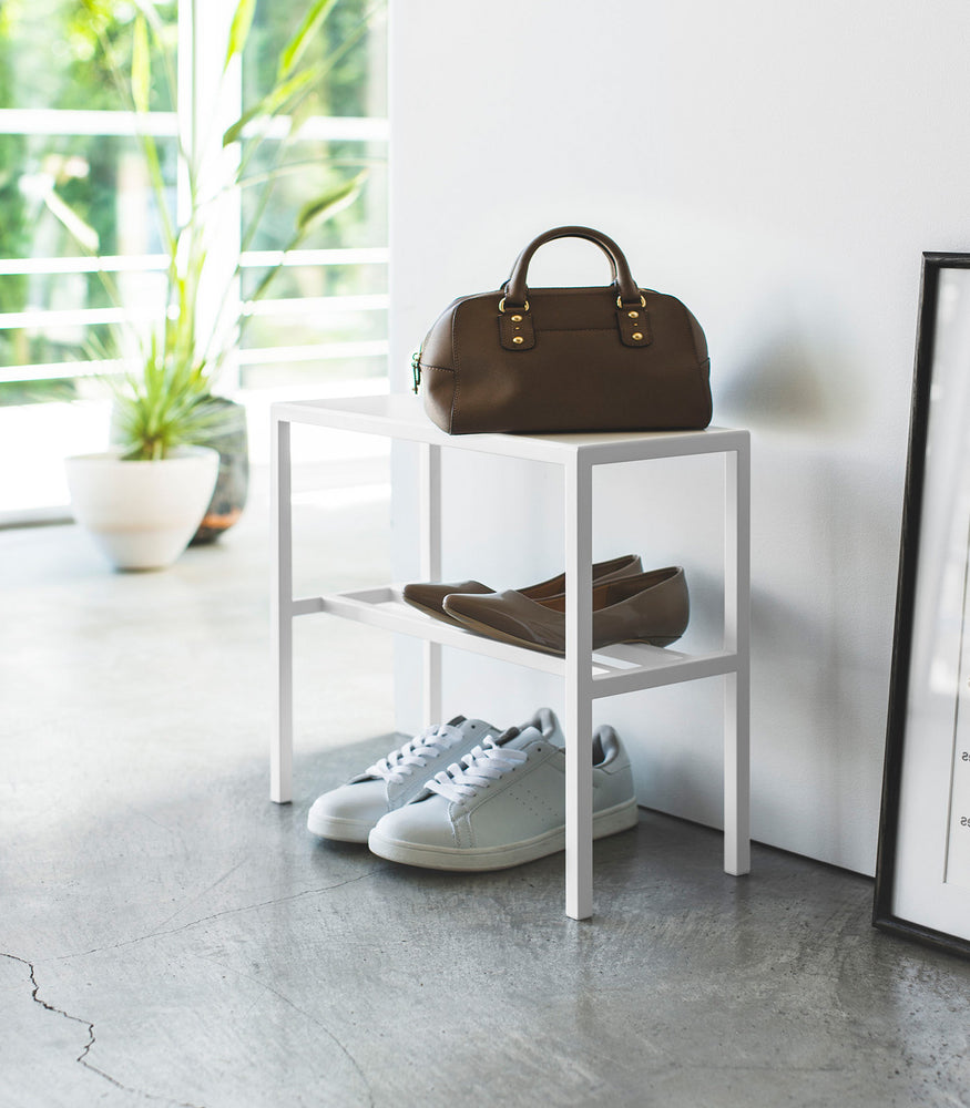 View 3 - Side view of white Shoe Organizer holding shoes and purse by Yamazaki Home.