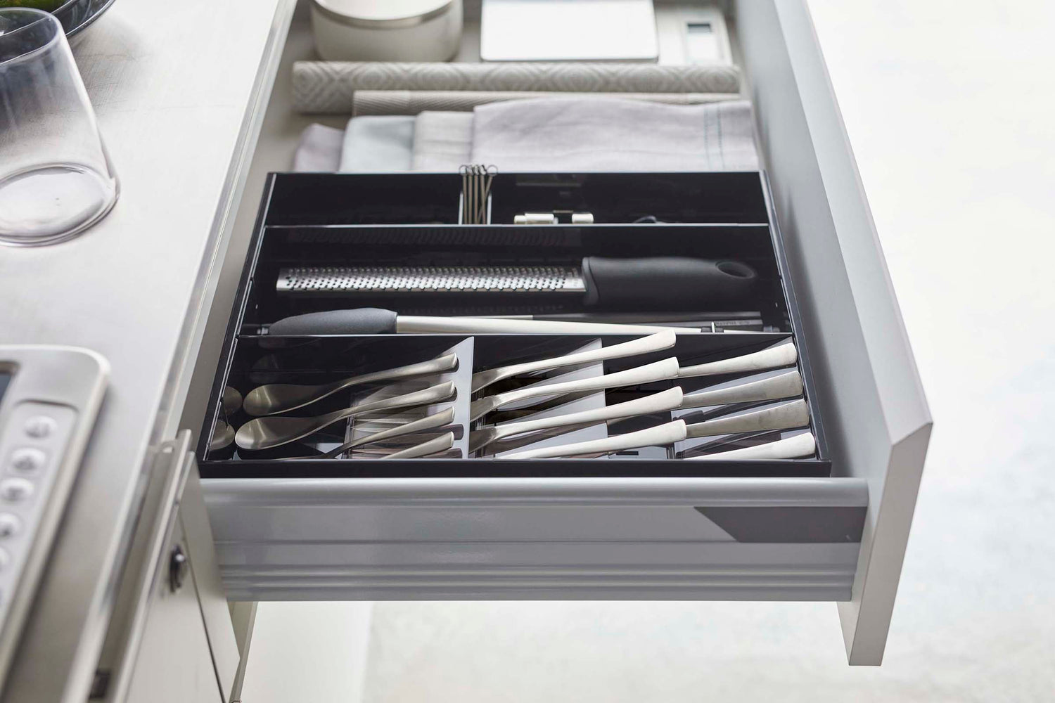 View 24 - Side view of black Expandable Cutlery Storage Organizer by Yamazaki Home.